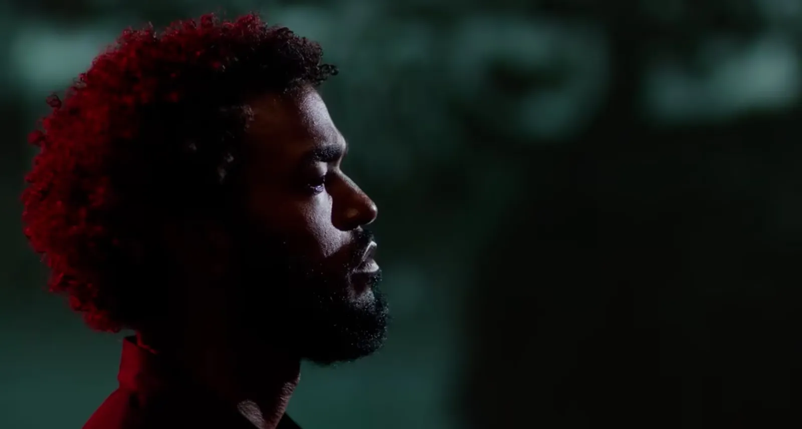 Portrait lit in red on set, from the custom content reel
